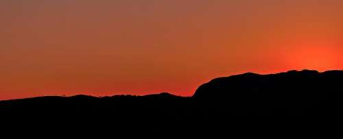 orange sky mountain dark silhouette