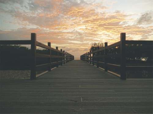 sunset sky clouds wood bridge