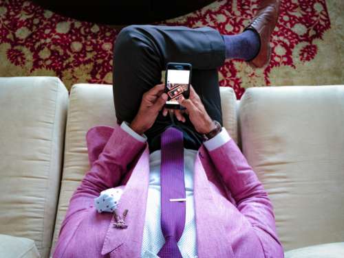 man pink suit mobile phone