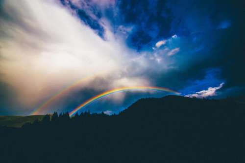 rainbow sky clouds storm landscape