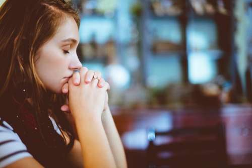 people girl praying church blur