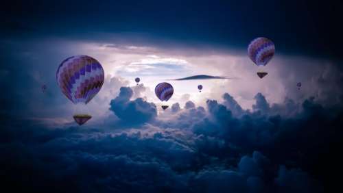 hot air balloon blue sky dark clouds
