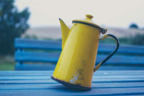 table bench yellow kettle thermos