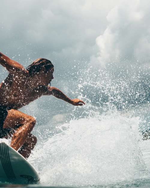 man surf action surfing water