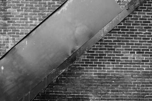 bricks wall staircase black and white city