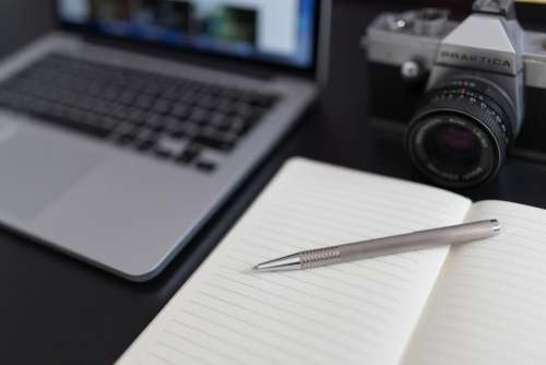 notepad notebook pen camera dslr