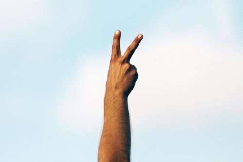 hand fingers peace clouds sky