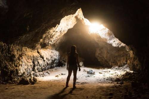 people travel adventure cave light