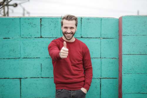 man thumbs up happy smile red