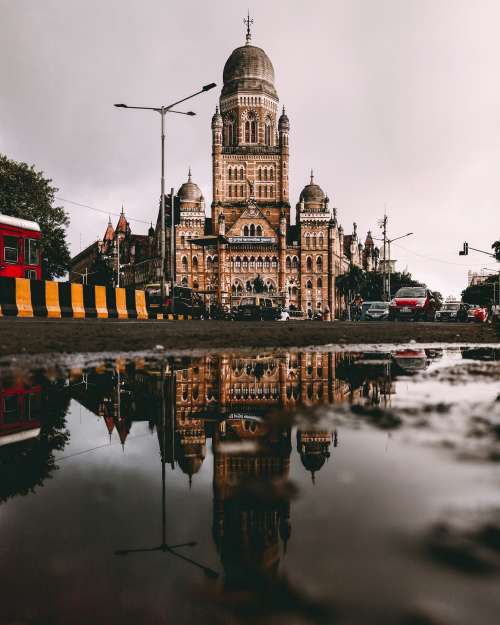 Building Reflected In Puddle Photo