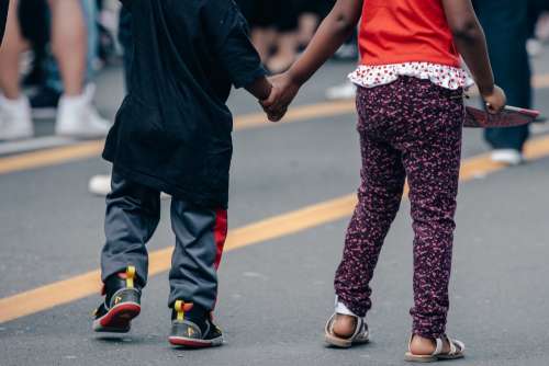 Children Holding Hands In The Street Photo