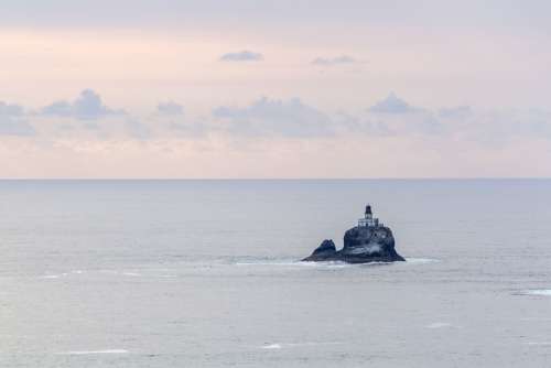 Lighthouse At Sea Photo