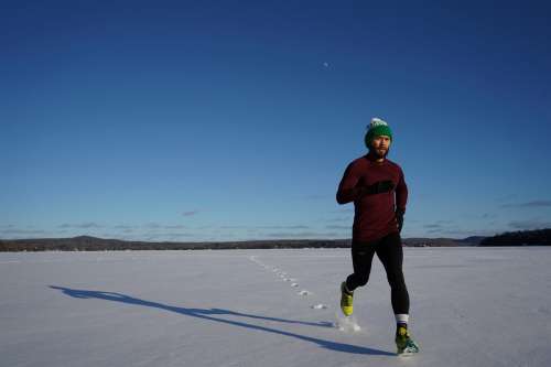 Man Runs Across Snow Photo