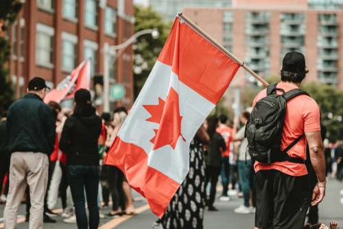 Man Standing With A Canadian Flag Photo
