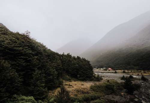 Misty Mountain Valley And A Huddle Of Woodland Huts Photo