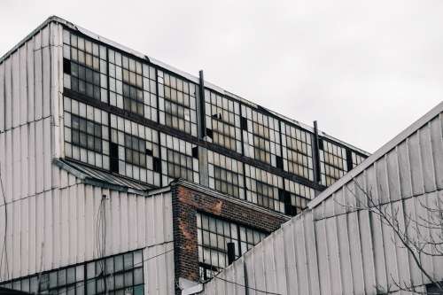 Shattered Windows In Grey Buildings Photo