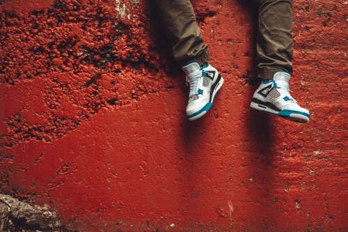 Sneakers In Front Of Red Wall Photo