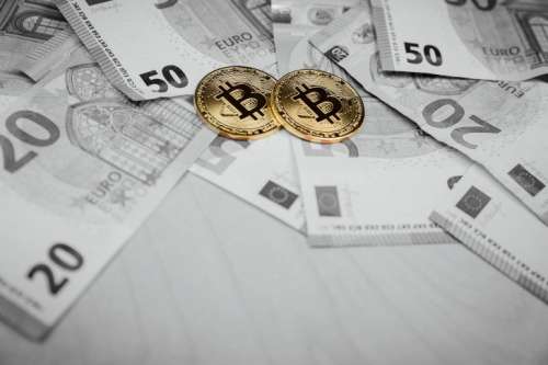 Bitcoins and euros, money and currency exchange rate concept