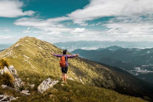 Man standing on the peak of the mountain