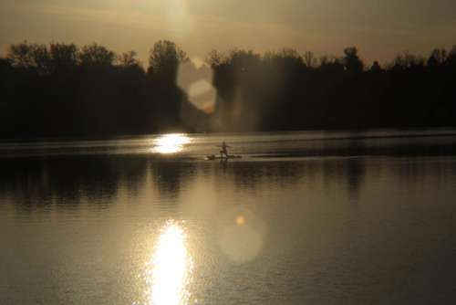 sun lake reflection paddle board yoga