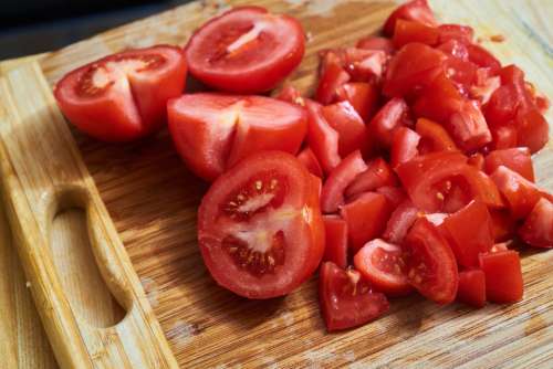 chopped tomatoes cutting board closeup