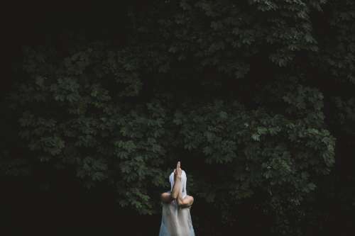 A Figure In White Gauze Strikes A Pose In The Woods Photo
