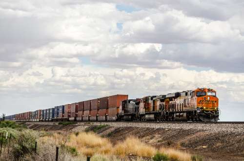 A Freight Train Hauls Containers Through The Plains Photo