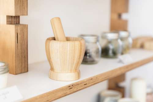 A Pestle And Mortar On A Wooden Shelf Photo