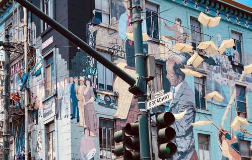 A Street Mural Depicts Musicians And Others Photo