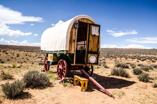 A Traditional Caravan Rests Under Blue Skies In The Plains Photo