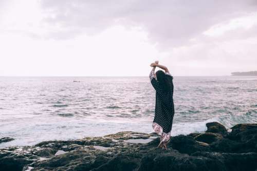 A Woman In A Beach Robe Poses On The Beach Photo