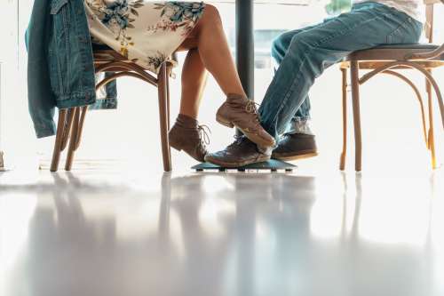 A Woman Plays Footsie With A Man In A Cafe Photo
