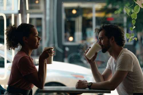 A Young Couple Chat Over Coffee Photo