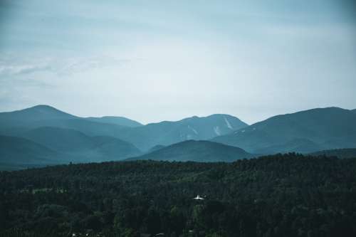 Hills Against A Blue Sky And A Small White Building Photo