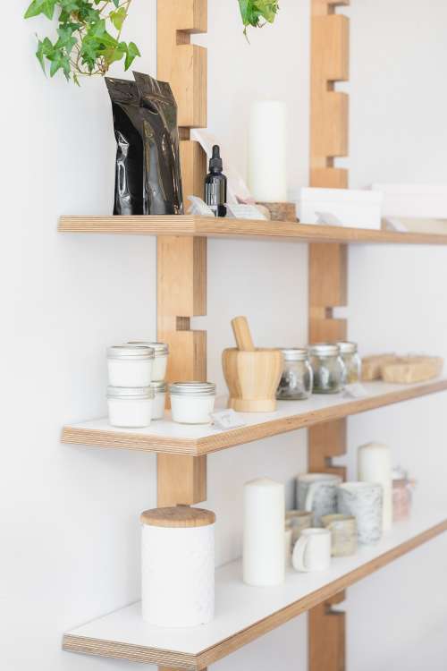 Jars, Candles And Ceramics On Wooden Shelves Photo