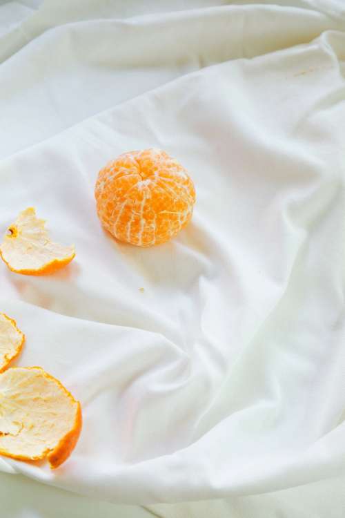 Peeled Orange On Cloth Photo
