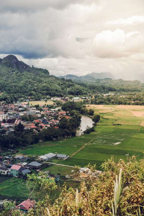 River Separates Community Of Houses From Rice Paddies Photo