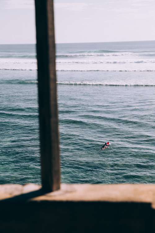 Solitary Surfer Paddles Out To The Waves Photo
