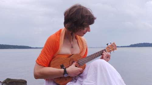 Young Woman Playing The Ukulele Music Instrument