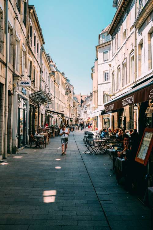 Tourists Sit Outside A Pizzeria On A European Street Photo