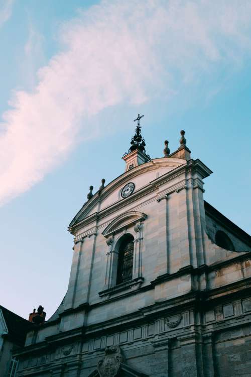 A Baroque Church Points A Crucifix At The Blue Sky Photo