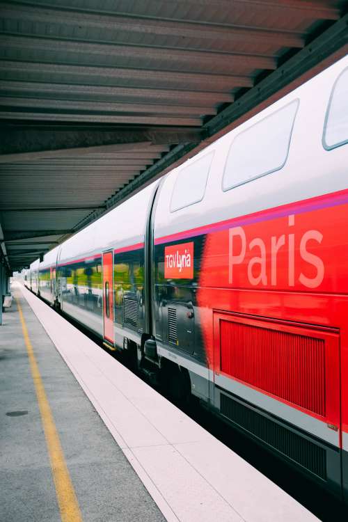 A Red Paris-Bound Train At A Platform Photo
