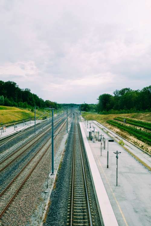 Bare Train Tracks Alongside An Empty Platform Photo