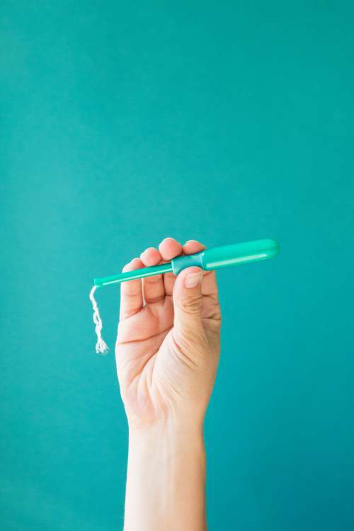 A Hand Holds A Tampon Applicator Photo