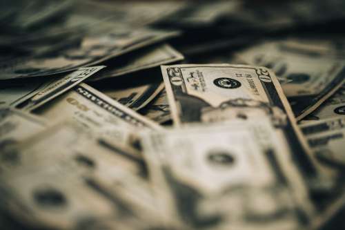 A Pile Of Dollar Bills Photo