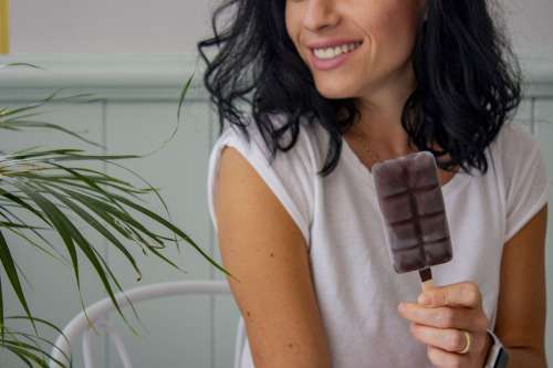 A Woman With Dark Hair Smiles Holding An Ice Cream Photo