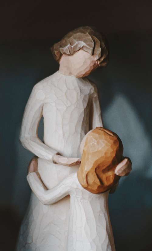 A Wooden Figurine Of Mother And Child Photo