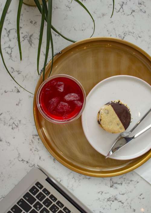 An Ice-Cream Sandwich And A Glass Of Red Juice Photo