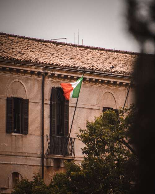 An Italian Flag Billows From a Balcony Photo