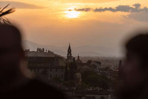 An Orange Sun Hovers In Early Dawn Over A City Skyline Photo